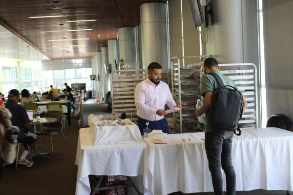 Uriel Delgato, in the American River College Student Center, serves free food during Bienvenida on Sept.16