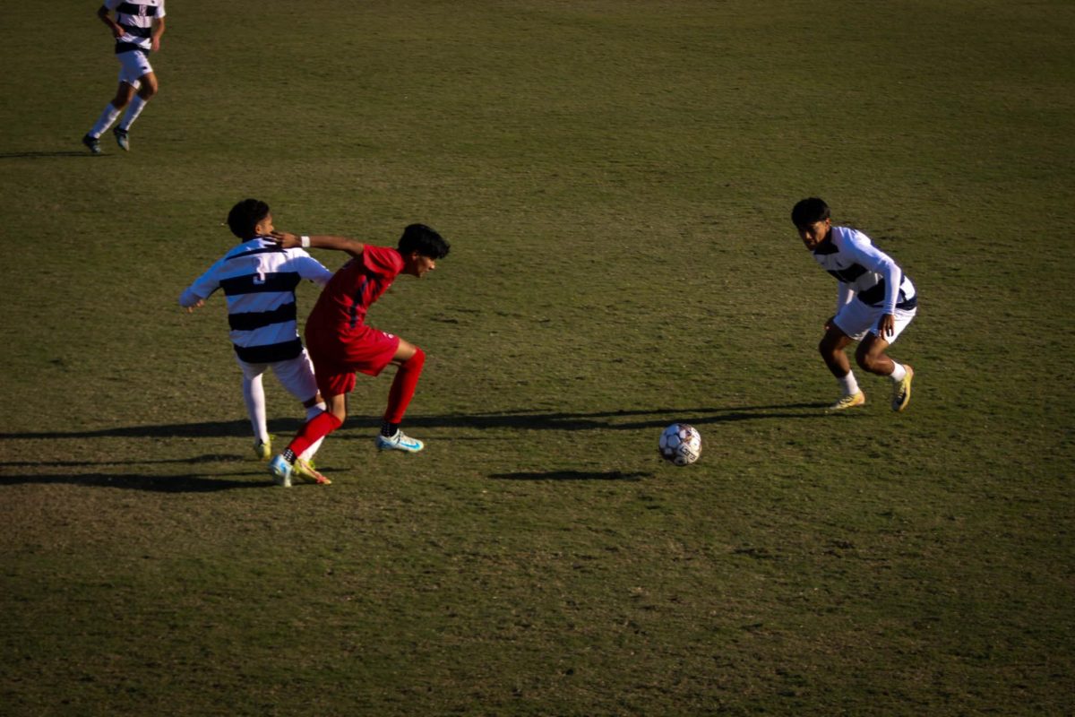 ARC forward Kevin Riveros brushes off the Santa Rosa defender as he tries to maintain the ball in the game against Santa Rosa on Nov. 8. (Photo by Elisha Chandra)