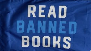 A “Read Banned Books” flag displayed outside Sacramento State’s library encourages readers to defy book bans. (Photo by Janelle Germain)