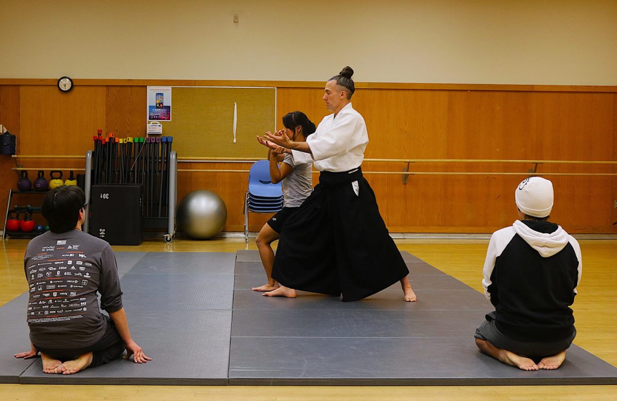 Sensei Christian Devine demonstrates a technique to his students in the Aikido club on February 10, 2024. (Photo by Elisha Chandra)