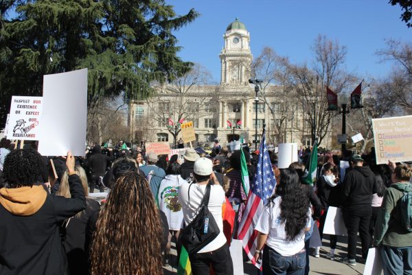 Leagues of protesters look on the dais under the view of Sacramento City Hall. (Photo by Will Forseth)