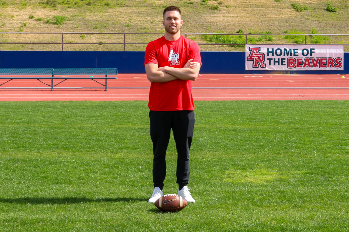  Coach Marco Baldacchino is (centered middle) standing behind a sign on the ARC Football Stadium, arms crossed with football on the field on March 6., ( Photo by Nairobi Sandoval Aguirre)