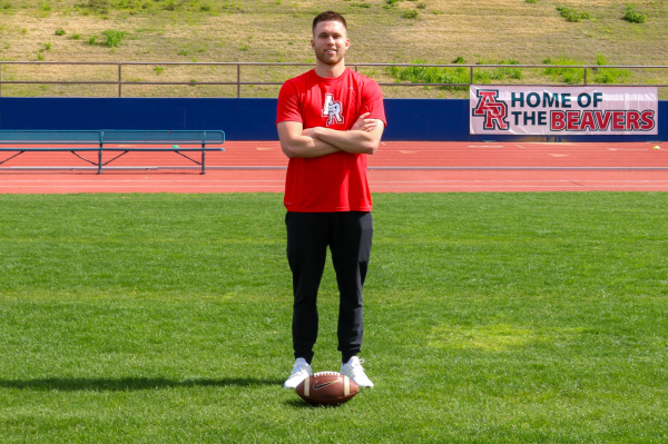  Coach Marco Baldacchino is (centered middle) standing behind a sign on the ARC Football Stadium, arms crossed with football on the field on March 6., ( Photo by Nairobi Sandoval Aguirre)